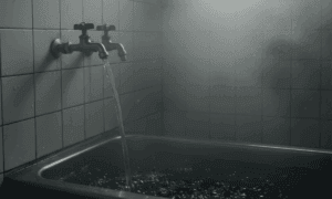 お湯と水が別々の蛇口からお風呂にお湯がはられている画像